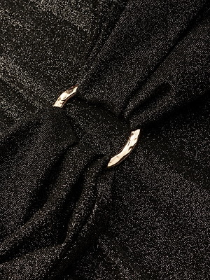 Close-up of the Lisa Plunge One-Piece Swimsuit in black, featuring shimmery fabric gathered at the center with a shiny silver ring, creating elegant folds and texture.