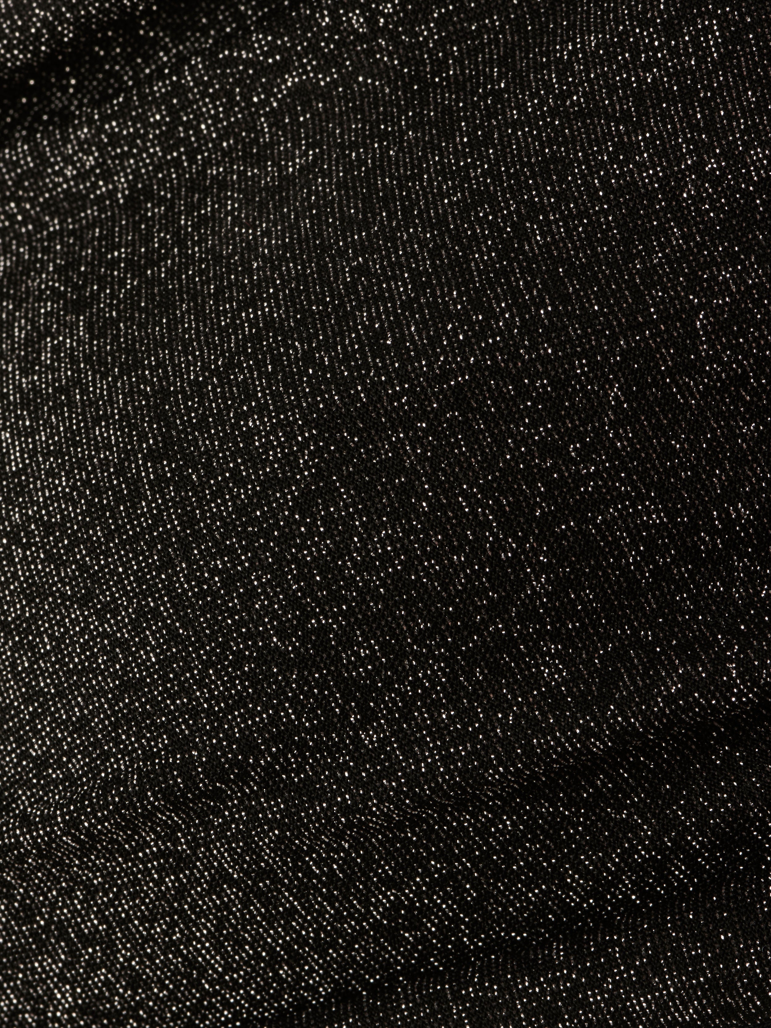 Close-up of the Krysta Halter Bikini Top’s textured black fabric, featuring a subtle sheen and fine weaving patterns reminiscent of metallic black.