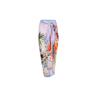 The Maribel Cover-Up Pareo is a colorful sarong skirt adorned with a vibrant tropical postcard print featuring palm trees, buildings, and beach scenes, tied at the waist and displayed against a plain white background.