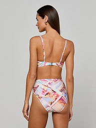 Woman with long brown hair, seen from the back and standing against a plain light background, wearing the Alexandria Bikini Top—a colorful, balconette swim top in a high-waisted bikini set featuring postcard print.