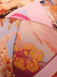 Close-up of the Alexandria Bikini Top, featuring colorful, patterned fabric with abstract shapes and floral prints in shades of pink, yellow, and orange—reminiscent of a vibrant postcard print—and detailed stitched seams.