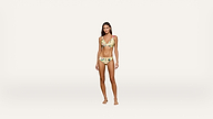 A woman stands barefoot wearing a yellow floral bikini against a plain white background, facing forward with a neutral expression.