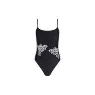 Remi One-Piece Swimsuit in black, featuring thin straps and intricate floral cutout designs along both sides of the waist for a glamorous poolside look, showcased against a plain white background.