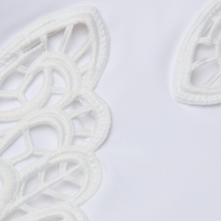 Close-up of the Remi One-Piece Swimsuit, featuring white fabric with intricate embroidered lace patterns, delicate butterfly appliqué, and cut-out details that create an elegant texture reminiscent of classic swimwear, set against a plain background.