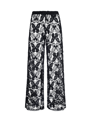 The Geraldine Cover-Up Pant features wide-leg, sheer lace with a floral pattern and an elastic waistband. Its see-through design offers a delicate, stylish look—ideal for chic resort wear or vacation lounging.