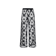 The Geraldine Cover-Up Pant showcases a relaxed bohemian vibe with its black, wide-leg design crafted entirely from sheer floral lace. Featuring a high waist and loose fit, these resort-ready pants are displayed against a plain white background.