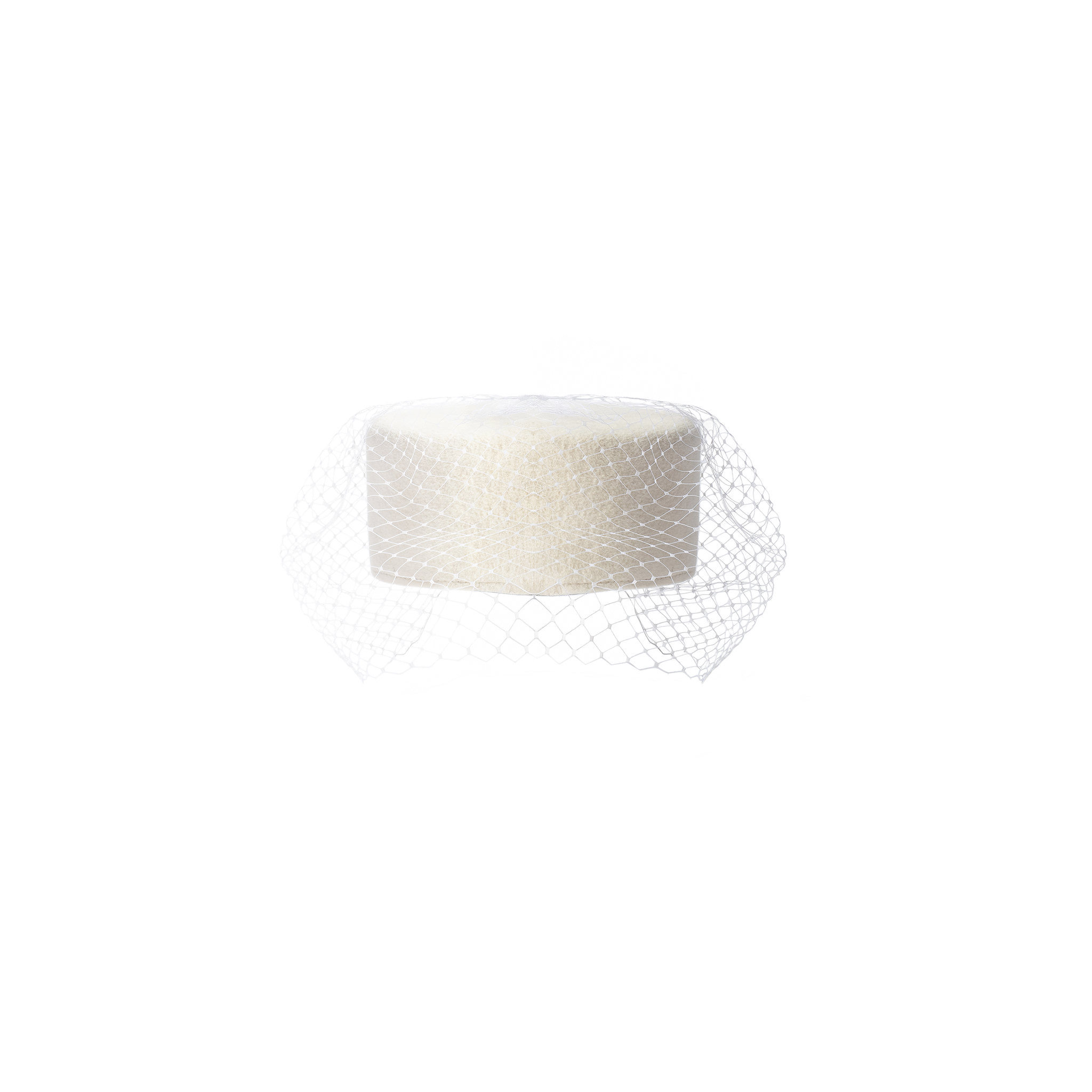 The Anstine Pillbox Hat is a white cylindrical hat featuring a fine mesh birdcage veil draped to one side, presented against a plain white background.