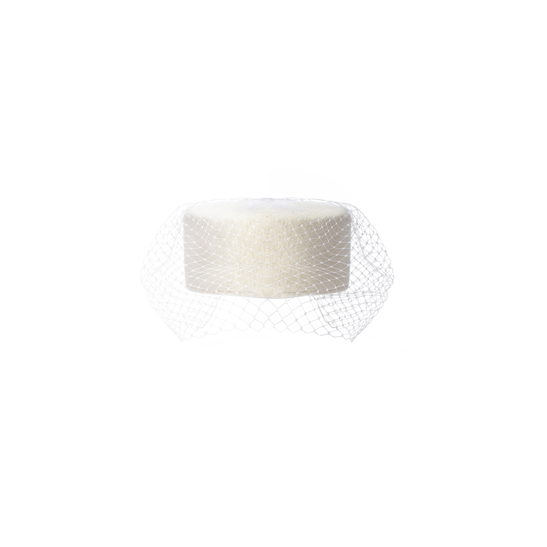 The Anstine Pillbox Hat is a white cylindrical hat featuring a fine mesh birdcage veil draped to one side, presented against a plain white background.