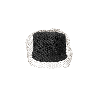 The Rawle Mini Cap—a black velvet pillbox hat featuring a delicate black veil elegantly draped over it—is displayed on a plain white background.