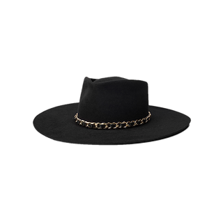 The Ferrante Hat by Gladys Tamez Millinery is a wide brim design expertly crafted from luxurious black felt, featuring a striking gold chain accent around the base of the crown, and is displayed on a plain white background.
