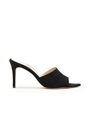 The Lolita Suede Open-Toe Mule is a black suede high heel with a stiletto heel, slip-on style, and memory foam insole for comfort, displayed in side profile against a white background.