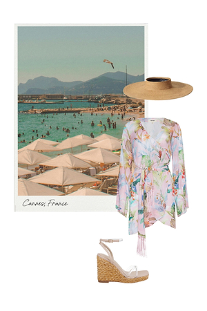 A collage featuring a vintage-style photo of a crowded Cannes beach, a wide-brimmed straw hat, a pastel floral wrap dress, and a pair of espadrille wedge sandals arranged on a white background.