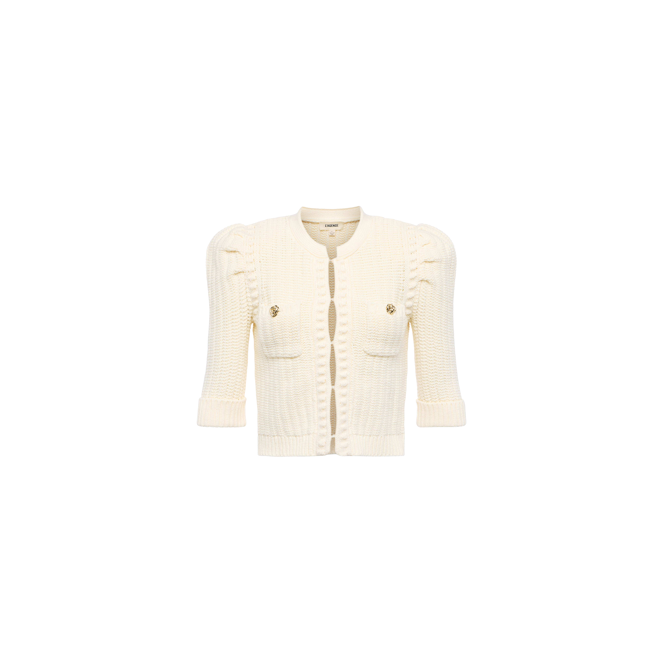 The Delilah Cropped Cardigan is a vintage-inspired white knit with textured detailing, puffed shoulders, front pockets, gold buttons, and three-quarter sleeves, shown against a plain white background.