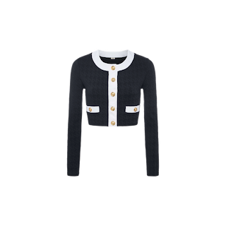 The Adaline Cardigan Cover-Up is a cropped black cardigan featuring white trim, gold buttons, long sleeves, and two front pockets. It is crafted from soft bouclé fabric and displayed on a plain white background.
