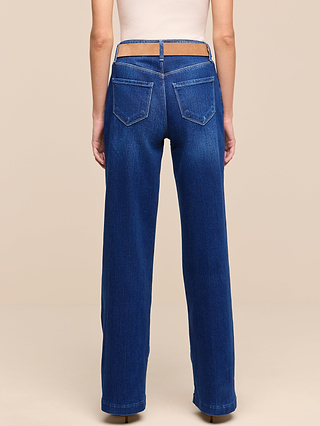 A person wearing the Petite Scottie Wide-Leg Jean from the Les Petites Collection, shown from the back. Crafted from stretch denim, these high-waisted blue jeans feature a cutout waistband, two back pockets, and a relaxed wide-leg fit.