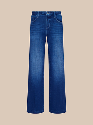 Shown against a plain beige background, the Petite Scottie Wide-Leg Jean from the Les Petites Collection in blue, crafted from stretch denim, features a high-rise, wide-leg silhouette with five pockets, belt loops, and a button-and-zip closure.