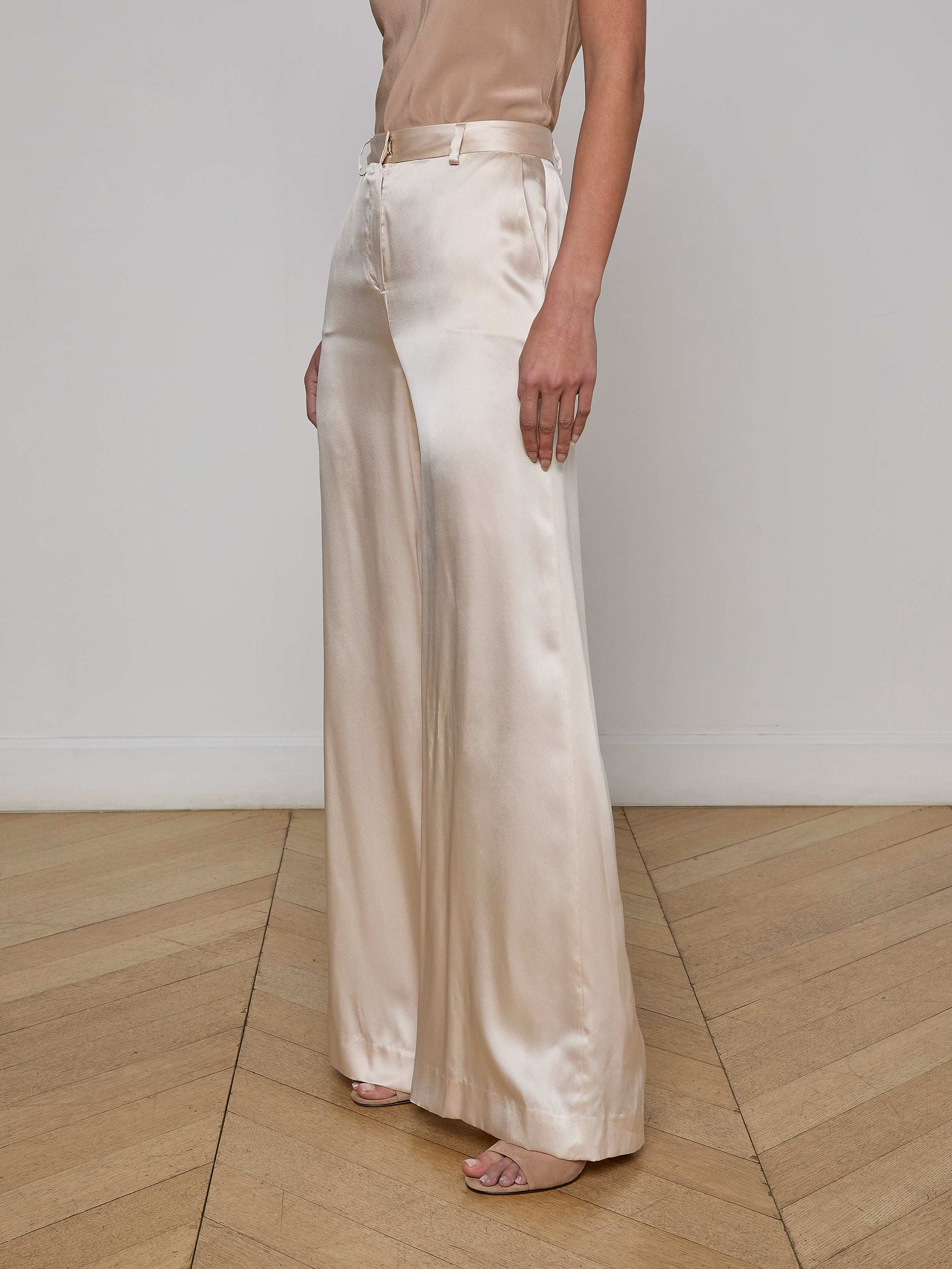 A person wearing the Gavin Silk Wide-Leg Pant in champagne and open-toe heels, shown from shoulders down against a plain white background.