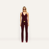 A person wearing a tailored burgundy Yelena Corduroy Vest and matching stretch corduroy pants with a belt.
