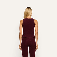 Back view of a person wearing a tailored maroon Yelena Corduroy Vest paired with matching stretch corduroy trousers.