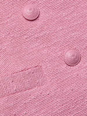 Close-up of the Brooke Tweed Blazer—a pink cotton-blend tweed blazer featuring two round pink buttons, a matching rectangular pocket detail, and a softly textured, bumpy surface.