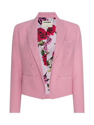 The Brooke Tweed Blazer is a light pink, double-breasted blazer in cotton-blend tweed with a floral rose lining, notched collar, and front buttons, shown on a white background.