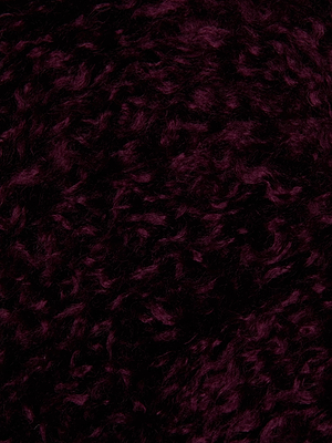 Close-up of the Aura Cropped Faux Fur Jacket by L'AGENCE in rich burgundy, featuring dark, curly plush texture and densely packed, soft wavy fibers.