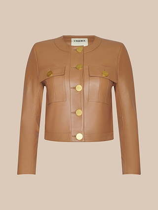 Deidra Cropped Leather Jacket in tan leather featuring long sleeves, large gold buttons down the front, and two front pockets with buttoned flaps. Displayed against a solid beige background.