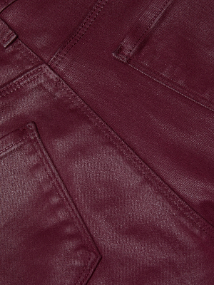 Close-up of the L'AGENCE Ruth Coated Straight-Leg Jean in maroon, featuring stitched seams and overlapping pockets that emphasize the coated denim's rich texture and vibrant color.