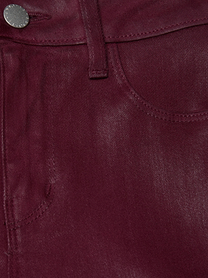Close-up of the front pocket and waistband of L'AGENCE's Selma Coated Bootcut Jean, showing the burgundy coated fabric texture, belt loop, and a silver button at the high-rise waist.