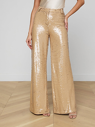 Wearing the Gavin Sequin Wide-Leg Pant, a white top, and open-toed heels, the person stands against a plain light background.