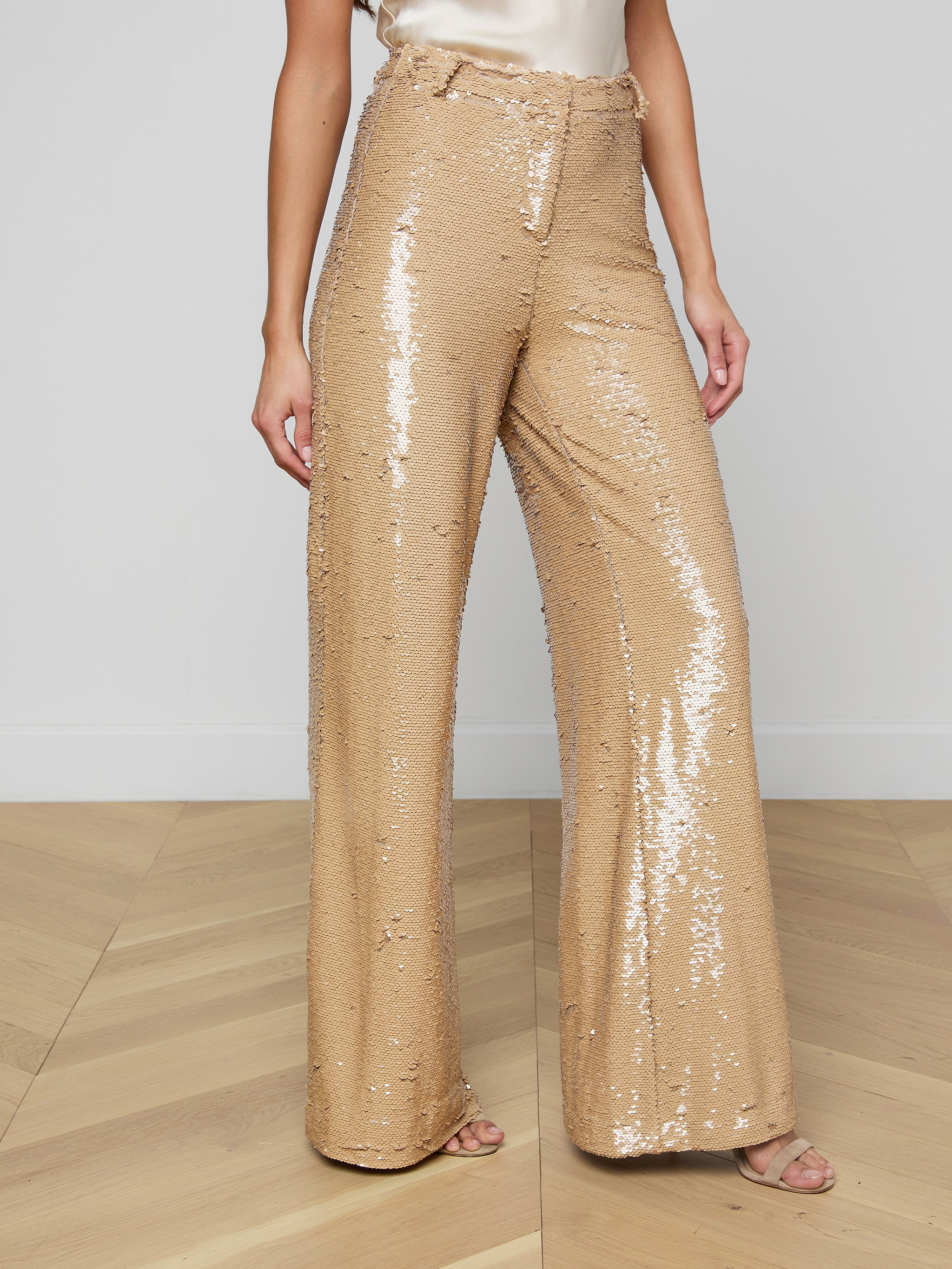 A person wearing the Gavin Sequin Wide-Leg Pant, paired with a light-colored satin top and open-toe heels, stands against a plain background.