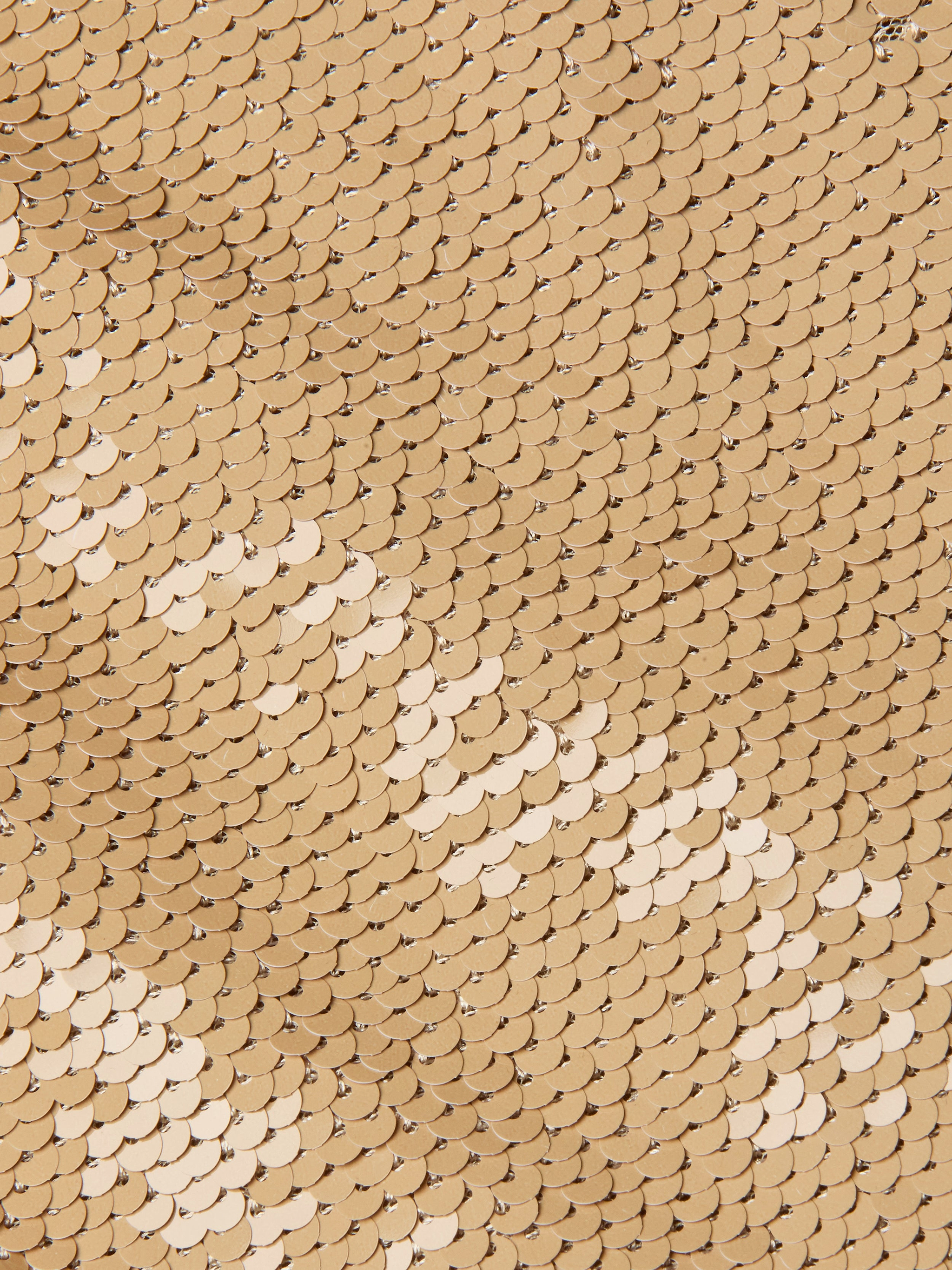 Close-up of overlapping gold sequins arranged in a uniform pattern, creating a shiny, textured surface reminiscent of the Gavin Sequin Wide-Leg Pant, with varying light reflections.