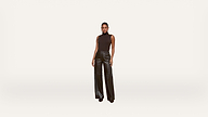 A woman stands facing forward, wearing a sleeveless black top and high-waisted, wide-leg black leather pants against a plain white background.