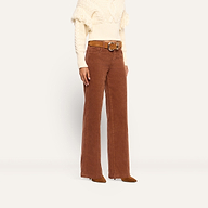 Person wearing cognac brown, high-rise, wide-leg Scottie Corduroy Wide-Leg Pant with a brown belt and a cream-colored fringe sweater.