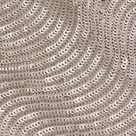 Close-up of shiny, champagne sequins sewn onto fabric in swirling, wave-like patterns creates a textured and reflective surface—perfect for special occasions or elevating your look with the elegant Zeta Sequin Maxi Skirt.