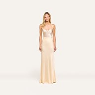 Woman wearing the Zeta Satin Maxi Skirt in cream, bias-cut with a satin finish, standing against a plain white background, facing forward with arms relaxed at her sides.