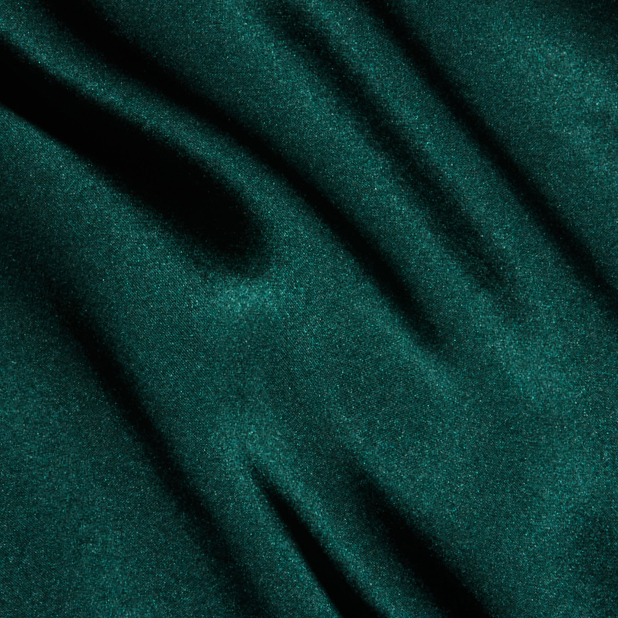 Deep green silk with a smooth, softly wavy drape and subtle sheen, evoking the rich texture and elegance of the Lexi Silk Camisole’s bias-cut silhouette and adjustable straps.