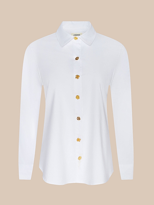 The Ellery Button-Down Shirt is a relaxed-fit, white long-sleeved shirt with a classic collar and gold decorative buttons, crafted from an organic cotton blend and shown against a plain beige background.