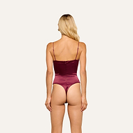A woman with long blonde hair is shown from the back, wearing the Dara Stretch-Satin Bodysuit in burgundy with adjustable straps against a plain light background.