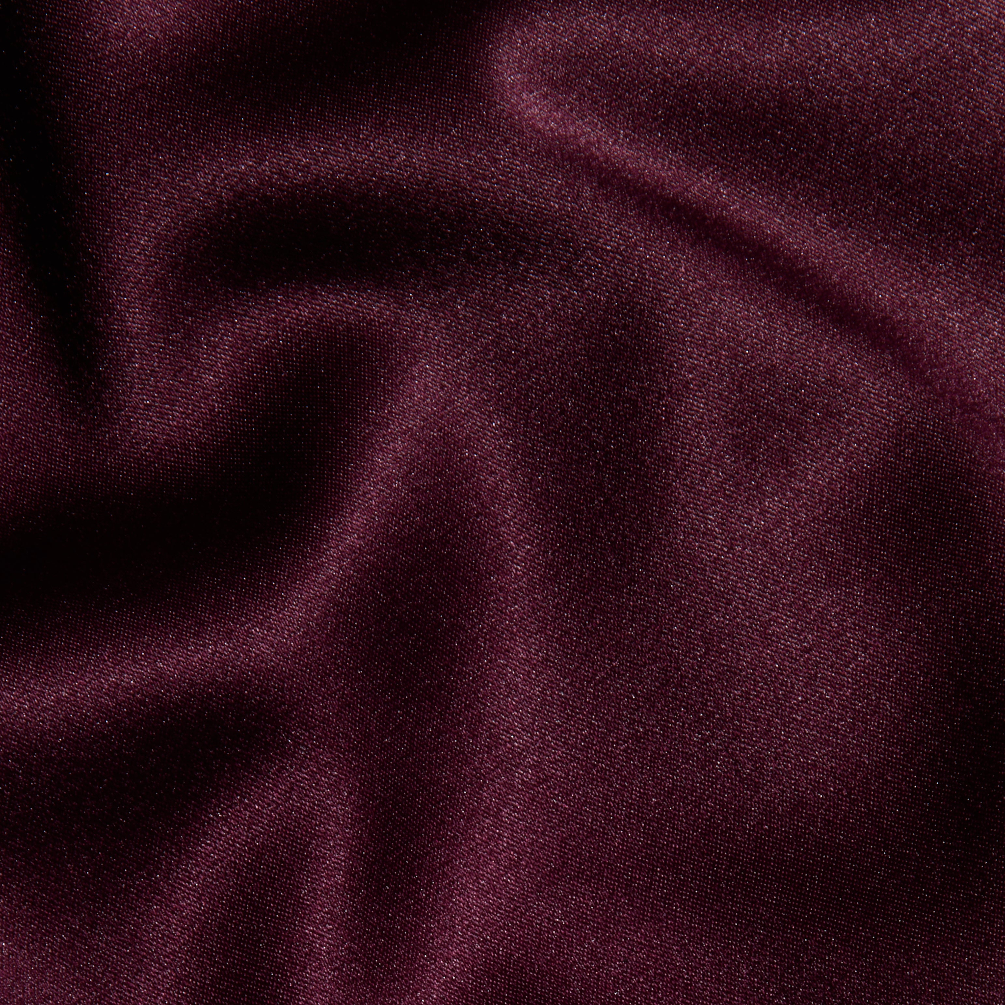 Close-up of smooth, deep burgundy fabric with soft folds and a subtle sheen, highlighting the luxurious and elegant appearance of the Dara Stretch-Satin Bodysuit with adjustable straps.