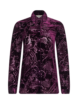 The Laurent Velvet Blouse by L'AGENCE is a relaxed-fit, long-sleeve shirt in purple and black burnout velvet with an ornate baroque pattern, pointed collar, and button-down front.