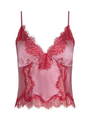 The Kimber Silk Lace Camisole is a pink cropped satin top with red lace trim at the neckline, hem, and sides. It features thin spaghetti straps and a V-shaped neckline.