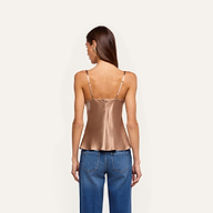 A person seen from behind wearing a bronze-colored Orlina Silk Camisole with thin straps and blue jeans.
