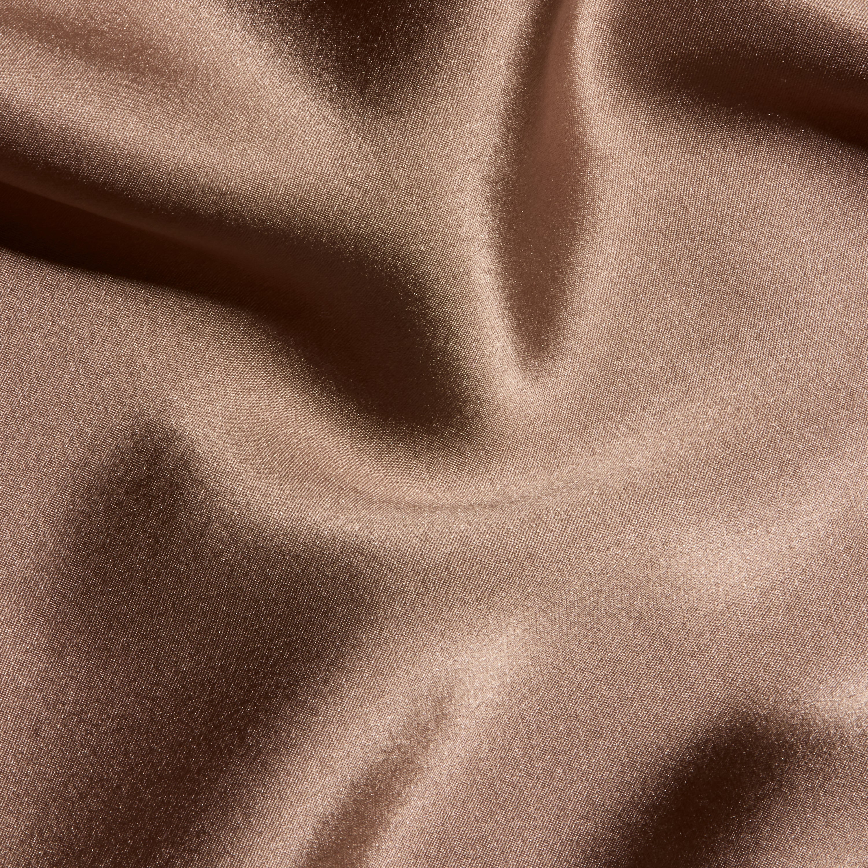 Close-up of the brown Orlina Silk Camisole, featuring gathered, lustrous fabric and soft folds.