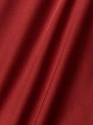 Close-up of the Eddie Tank in smooth poppy red bias-cut satin, featuring subtle shadows and diagonal folds that highlight its texture and depth.