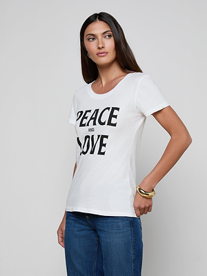 A woman with long dark hair wears the Cory Graphic Tee—a pure white cotton shirt with 