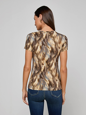 A woman with long brown hair, wearing the Ressi Fitted Tee in a bestselling brown and gold feather print and blue jeans, is shown from the back against a plain light background.