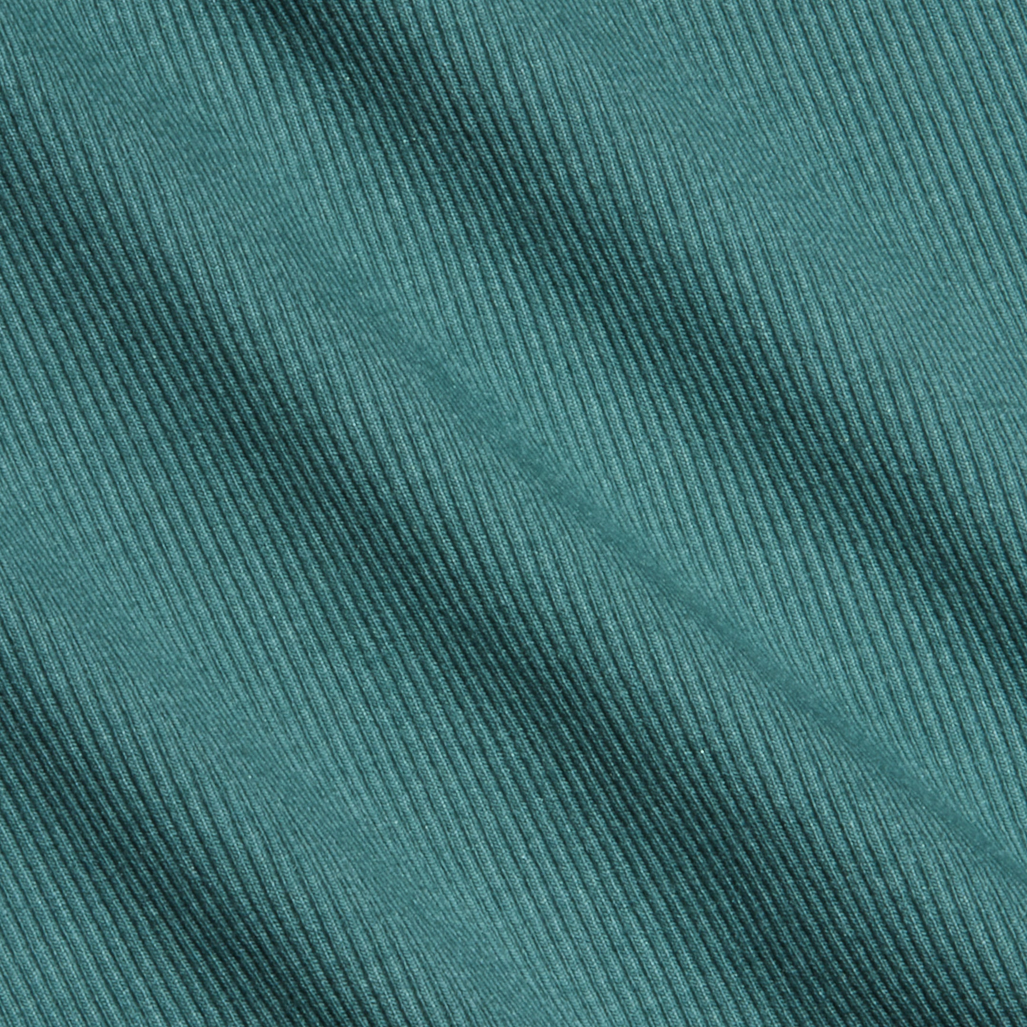Close-up of teal high recovery stretch rib fabric with diagonal textured lines running across the surface. The material appears soft and features evenly spaced, raised ridges, making it ideal for a sculpted fit like the Nica Scoopneck Bodysuit.