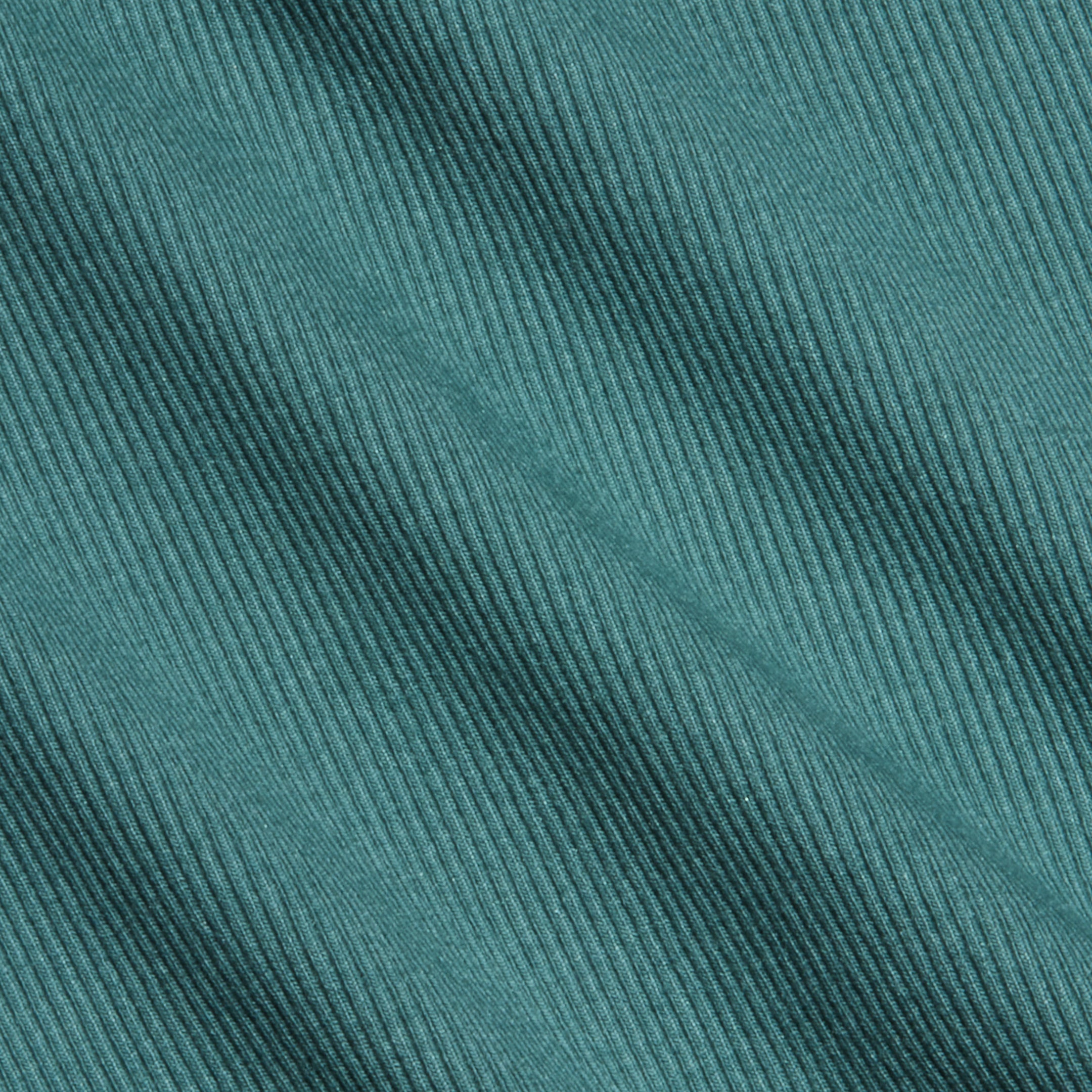 Close-up of teal high recovery stretch rib fabric with diagonal textured lines running across the surface. The material appears soft and features evenly spaced, raised ridges, making it ideal for a sculpted fit like the Nica Scoopneck Bodysuit.