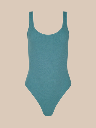 A teal Nica Scoopneck Bodysuit swimsuit, featuring ribbed fabric, a scoop neckline, and high-cut legs with high recovery stretch material, is displayed on a solid light beige background.